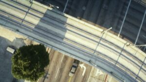 Overhead view of an impound lot entrance under the freeway in FiveM