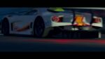 Race car at speed on the Grand Senora Raceway circuit at dusk